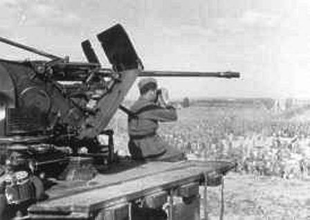 German soldier guards Soviet prisoners of war at the Uman camp in the Ukraine